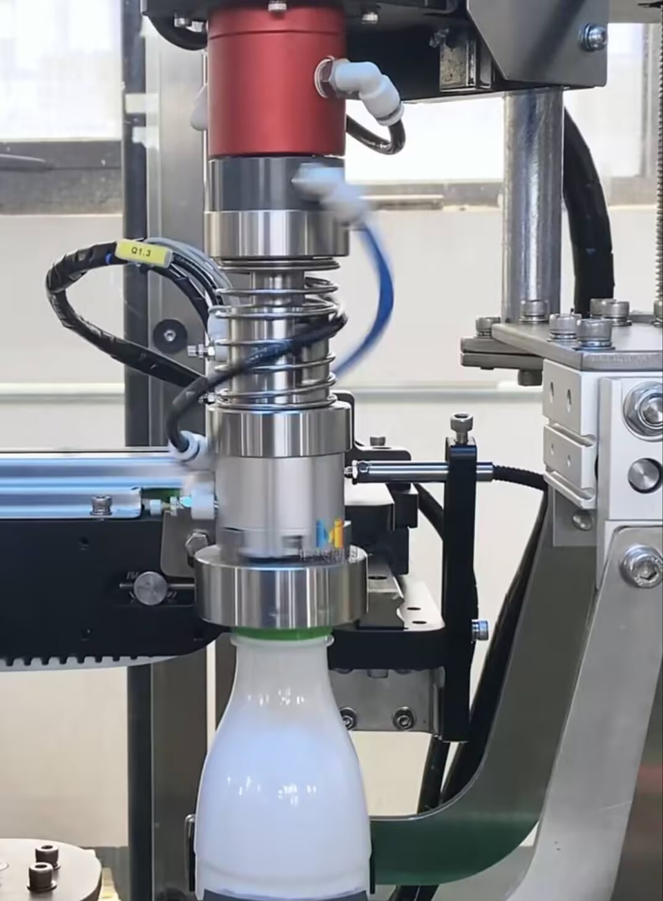 BP-2P-16-0001 supplying two compressed-air passages to a pneumatic bottle-cap gripper