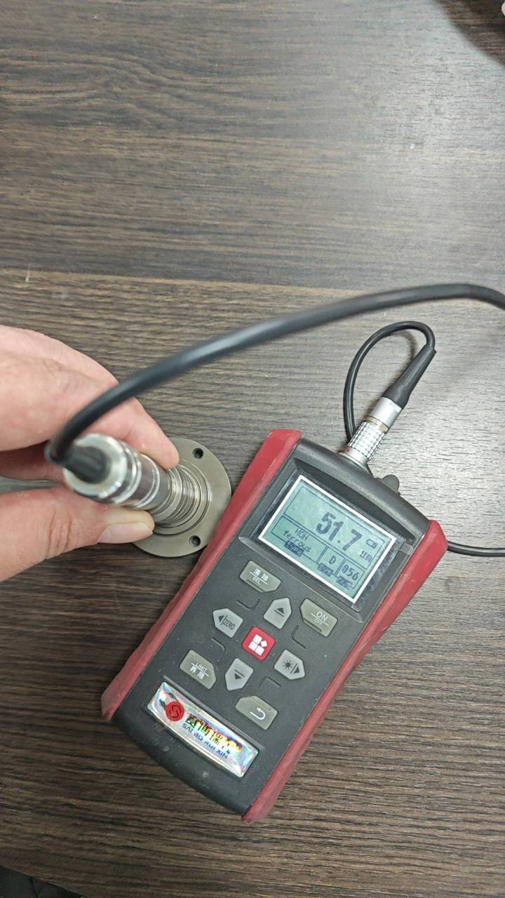 Coating-thickness gauge displaying 51.7 micrometres on a hard-anodized rotor sample