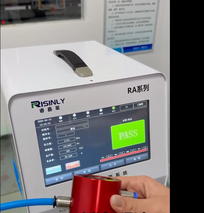 Leak-test station showing PASS during one individual passage test cycle